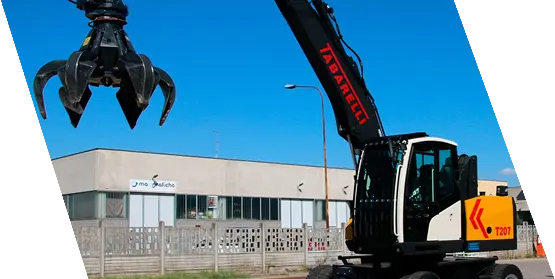 Caricatore industriale Tabarelli in azione in un impianto di riciclaggio rottami.