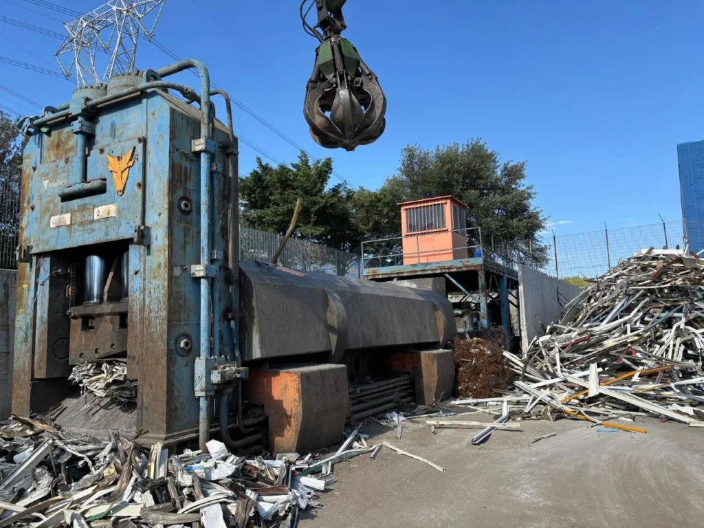 Three quarter view of used Taurus C872HD scrap shear baler cutting metal scrap